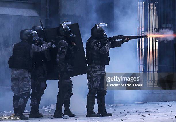 Military police fire a rubber bullet towards protestors during a public servants protest against proposed austerity measures on December 6, 2016 in...