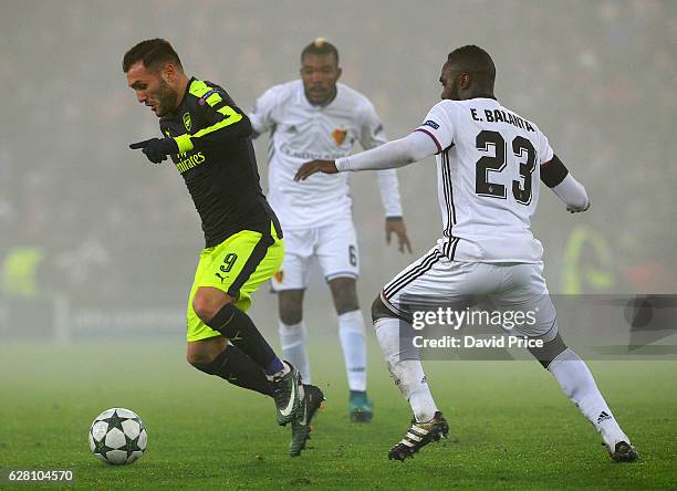 Lucas Perez of Arsenal takes on Eder Balanta of Basel during the UEFA Champions League match between FC Basel and Arsenal at St. Jakob-Park on...