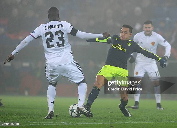 Alexis Sanchez of Arsenal takes on Eder Balanta of Basel during the UEFA Champions League match between FC Basel and Arsenal at St. Jakob-Park on...