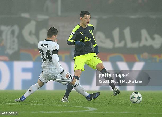 Granit Xhaka of Arsenal breaks past Taulant Xhaka of Basel during the UEFA Champions League match between FC Basel and Arsenal at St. Jakob-Park on...