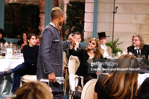 Pharrell Williams walks the runway in front of Carine Roitfeld during the "Chanel Collection des Metiers d'Art 2016/17 : Paris Cosmopolite" : Show at...