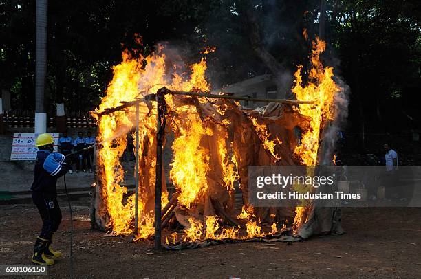 Team demonstrating fire fighting skills during 70th foundation day of MP Home Guards and Civil Defense on December 6, 2016 in Bhopal, India.