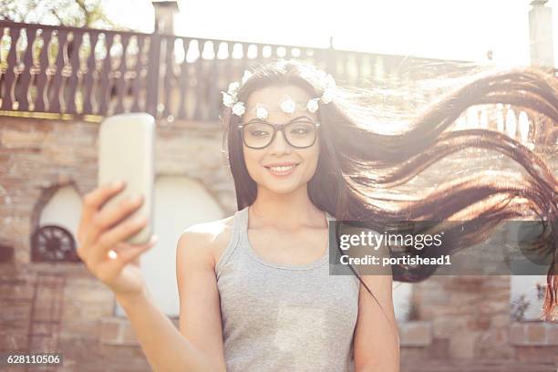 carefree boho woman making selfie outdoors - chinese model stock pictures, royalty-free photos & images