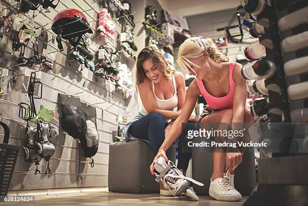 shopping in sports store - inline skate stock pictures, royalty-free photos & images
