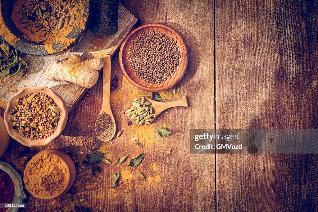 Spices and Herbs on Wooden Background