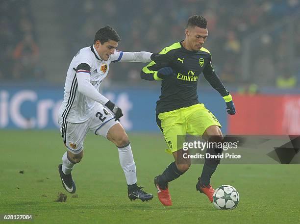 Kieran Gibbs of Arsenal takes on Mohamed Elyounoussi of Basel during the UEFA Champions League match between FC Basel and Arsenal at St. Jakob-Park...