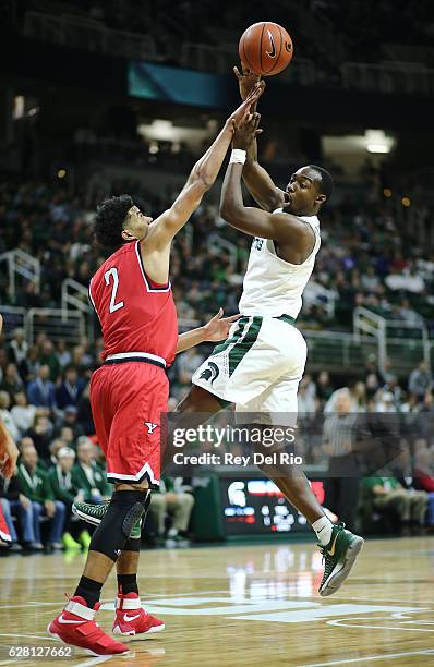 Joshua Langford of the Michigan State Spartans looks to pass the ball against Devin Haygood of the Youngstown State Penguins at the Breslin Center on...