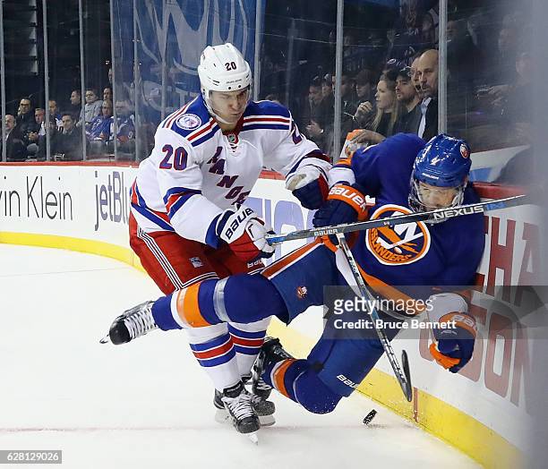 Chris Kreider of the New York Rangers checks Dennis Seidenberg of the New York Islanders into the boards during the third period at the Barclays...