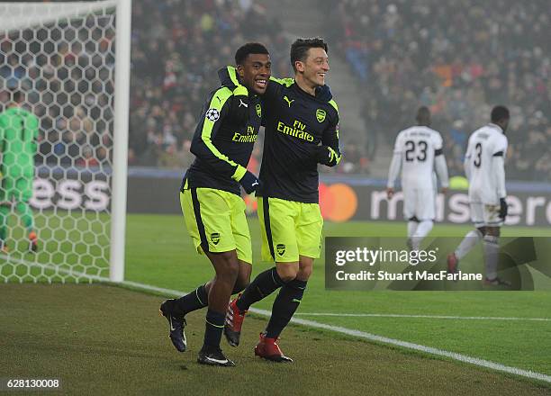 Alex Iwobi celebrates scoring the 4th Arsenal goal with Mesut Ozil during the UEFA Champions League match between FC Basel and Arsenal at St....