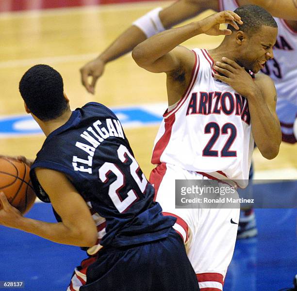 Guard Jason Gardner of Arizona grabs his throat after a control foul by guard Jason Flanigan of Ole Miss in the first period of the NCAA Midwest...