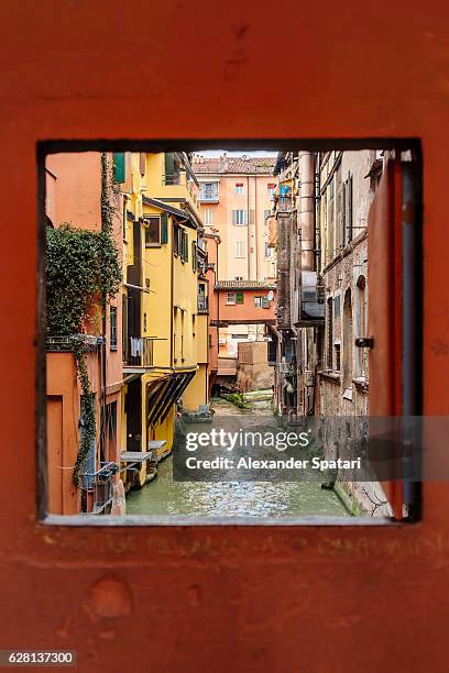 view to the canal through square window, bologna, emilia-romagna, italy - bologna italy stock pictures, royalty-free photos & images