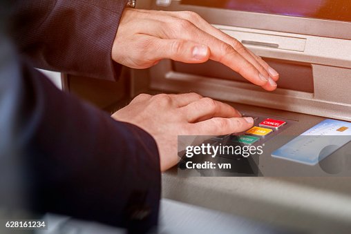 Entering ATM cash machine PIN code Entering ATM cash machine PIN code