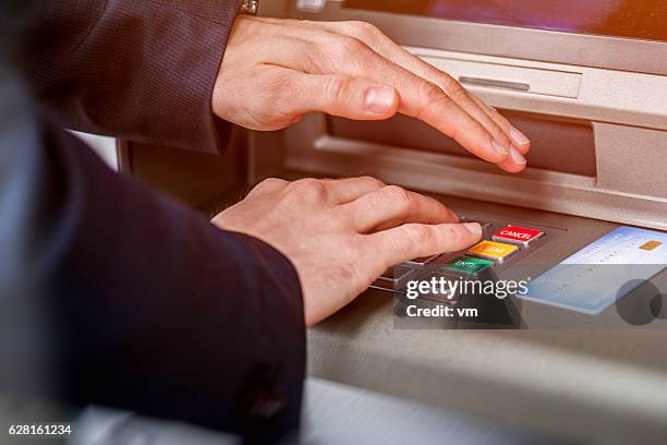 entering atm cash machine pin code - pin entry stock pictures, royalty-free photos & images