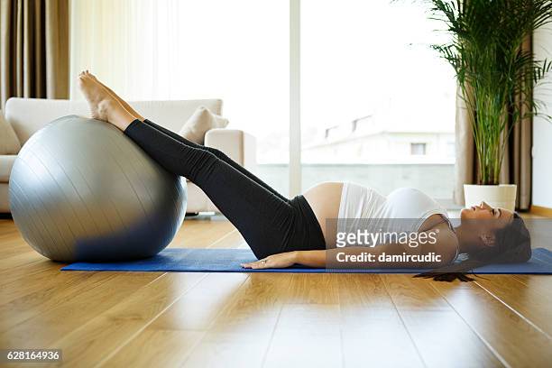 pregnant woman doing pilates exercises - mass unit of measurement stock pictures, royalty-free photos & images