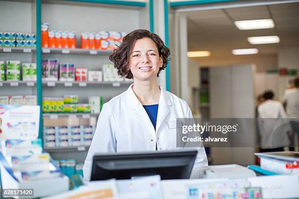 pharmacist working at cashier checkout counter - cure berlin 2016 stock pictures, royalty-free photos & images