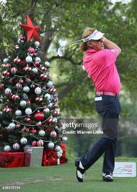 Miguel Angel Jimenez of Spain tees off next to a Christmas tree during the pro-am ahead of the UBS Hong Kong Open at The Hong Kong Golf Club on...