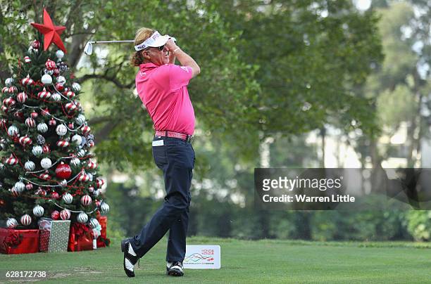 Miguel Angel Jimenez of Spain tees off next to a Christmas tree during the pro-am ahead of the UBS Hong Kong Open at The Hong Kong Golf Club on...
