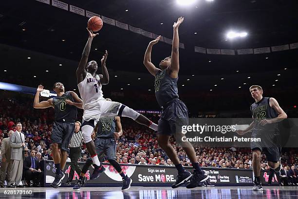 Rawle Alkins of the Arizona Wildcats attempts a shot over John Edgar Jr. #11 of the UC Irvine Anteaters during the first half of the college...