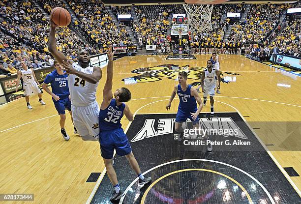 Forward Shaquille Morris of the Wichita State Shockers scores over guard Mike Crawford of the St. Louis Billikens during the second half on December...