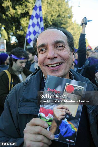 Protester holds the Italian Constitution during a demonstration to demand the resignation of Silvio Berlusconi and Berlusconi's government on...