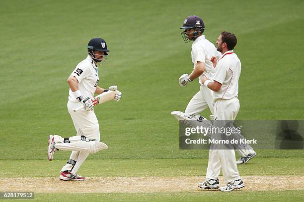 Ed Cowan and Ryan Carters of the NSW Blues run between the wickets during day three of the Sheffield Shield match between South Australia and New...
