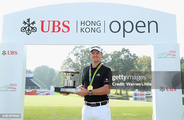 Defending champion, Justin Rose of England poses with the UBS Hong Kong Open trophy and his Olympic gold medal ahead of the UBS Hong Kong Open at The...