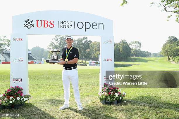 Defending champion, Justin Rose of England poses with the UBS Hong Kong Open trophy and his Olympic gold medal ahead of the UBS Hong Kong Open at The...