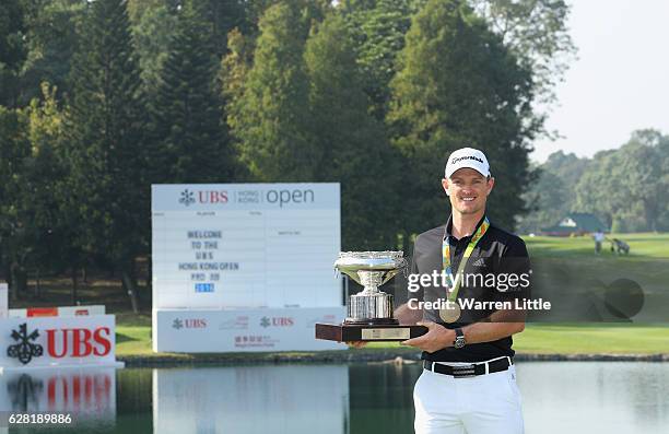 Defending champion, Justin Rose of England poses with the UBS Hong Kong Open trophy and his Olympic gold medal ahead of the UBS Hong Kong Open at The...