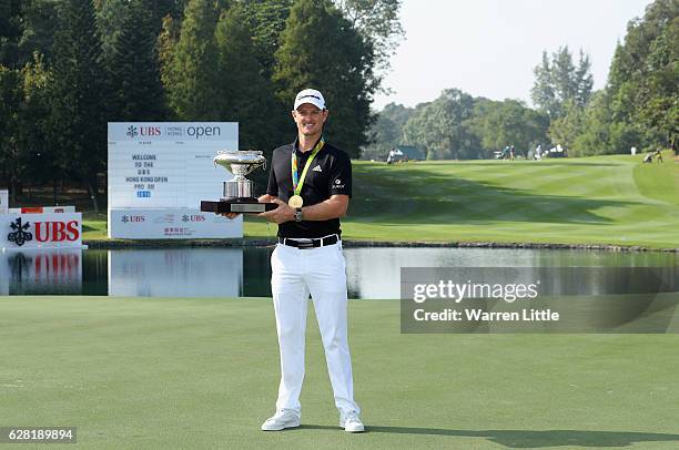 Defending champion, Justin Rose of England poses with the UBS Hong Kong Open trophy and his Olympic gold medal ahead of the UBS Hong Kong Open at The...