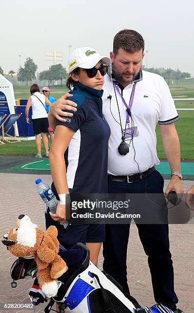 Anne-Lise Caudal of France is consoled by the Tournament Director Michael Wood after her caddie collapsed on the course, which led to an immediate...