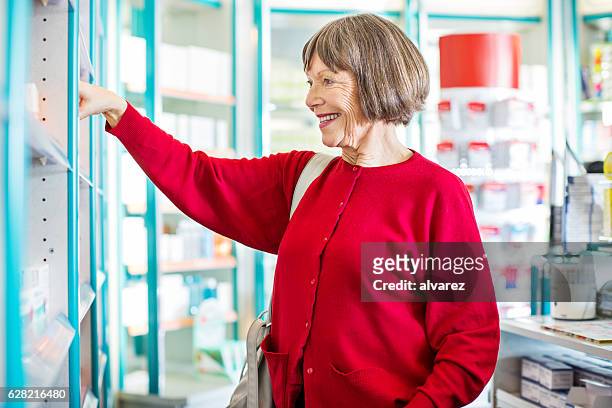senior customer buying medicine at drugstore - cure berlin 2016 stockfoto's en -beelden