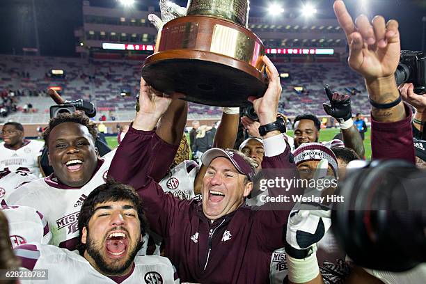 Head Coach Dan Mullen of the Mississippi State Bulldogs celebrates with his team after winning the Egg Bowl against the Mississippi Rebels at...