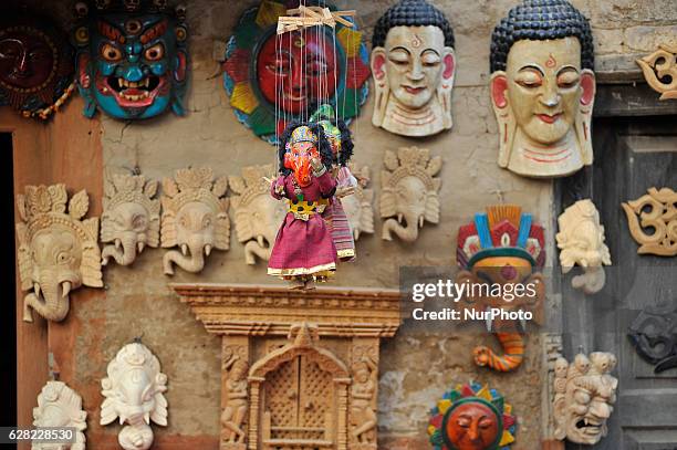 The finished wood carved handicraft products displayed on a wall, which is for sale carved by ASMITA MAHARJAN, 28 yrs. Old, at Khokana, Patan, Nepal...