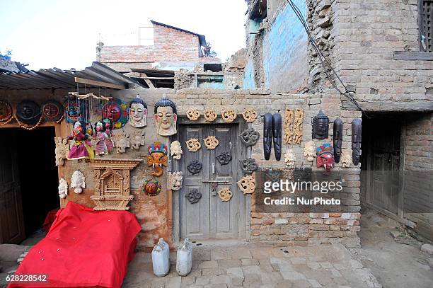 The finished wood carved handicraft products displayed on a wall, which is for sale carved by ASMITA MAHARJAN, 28 yrs. Old, at Khokana, Patan, Nepal...