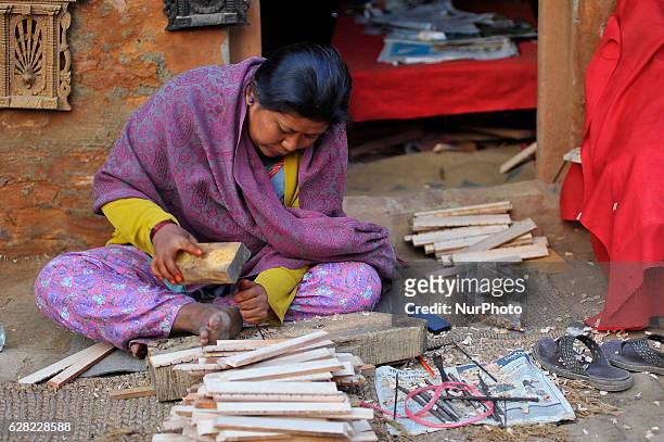 Yrs. Old, works on her carving business at Khokana, Patan, Nepal on Tuesday, December 06, 2016. Although her home was destroyed by last year's...