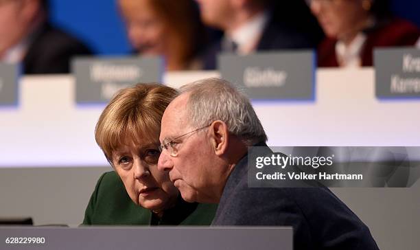 Chancellor and Chairwoman of the German Christian Democrats Angela Merkel speaks on the Podium with the Federal Minister for Finance, Wolfgang...