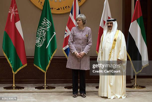 British Prime Minister Theresa May waits with the King of Bahrain, Hamad bin Isa Al Khalifa, for a group photo on the second day of the Gulf...