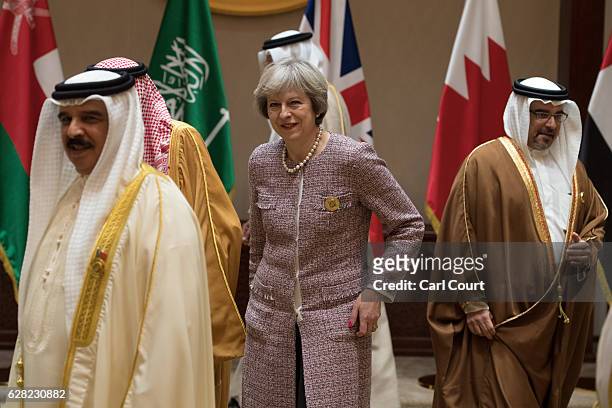 British Prime Minister Theresa May leaves with Gulf leaders after posing for a group photo on the second day of the Gulf Cooperation Council summit,...