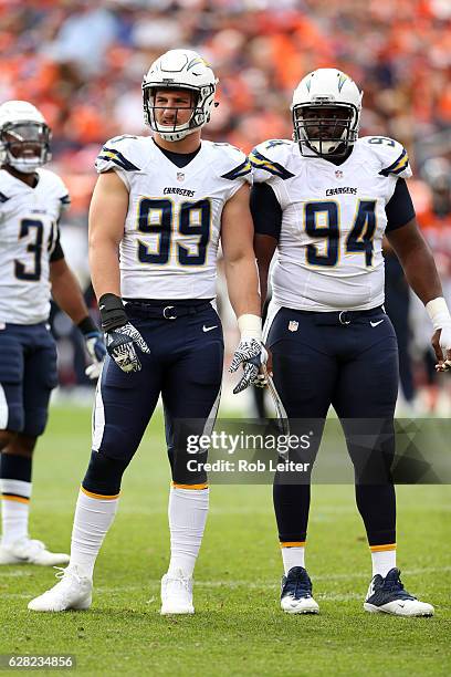 Joey Bosa and Corey Liuget of the San Diego Chargers look on during the game against the Denver Broncos at Sports Authority Field At Mile High on...