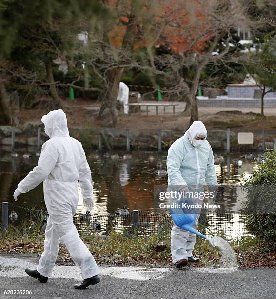 Officials of Higashiyama Zoo and Botanical Gardens in the central Japan city of Nagoya sterilize the facility on Dec. 7 a day after a tundra swan...