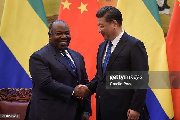 Chinese President Xi Jinping shakes hand of Gabon's President Ali Bongo Ondimba after Gabonese and Chinese delegates signed economic contracts at the...