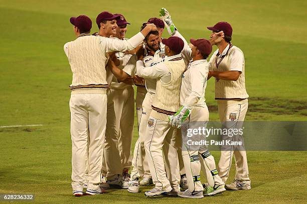 Michael Neser of Queensland celebrates the wicket of Michael Klinger of Western Australia during day three of the Sheffield Shield match between...