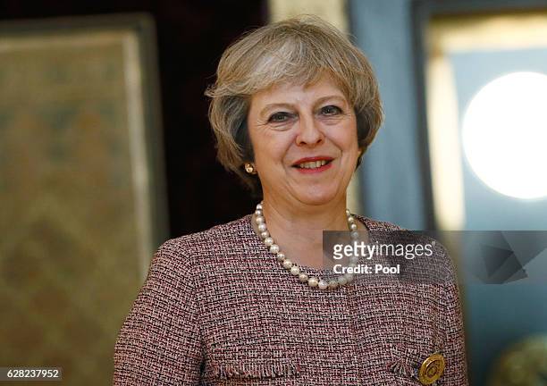 Britain's Prime Minister Theresa May smiles as she meets King of Bahrain King Hamad Bin Isa Khalifa on December 7, 2016 in Manama, Bahrain.
