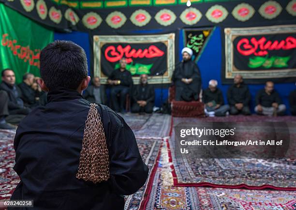Iranian shiite muslim men listening to a Mullah who preaches during Muharram, Central County, Theran, Iran on October 7, 2016 in Theran, Iran.