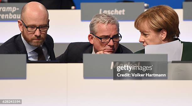 Chancellor and Chairwoman of the German Christian Democrats Angela Merkel speakes at the podium with the Minister of the Interior in...