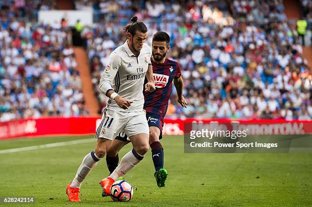 Gareth Bale of Real Madrid battles for the ball with Fran Rico of SD Eibar during their La Liga match between Real Madrid CF and SD Eibar at the...