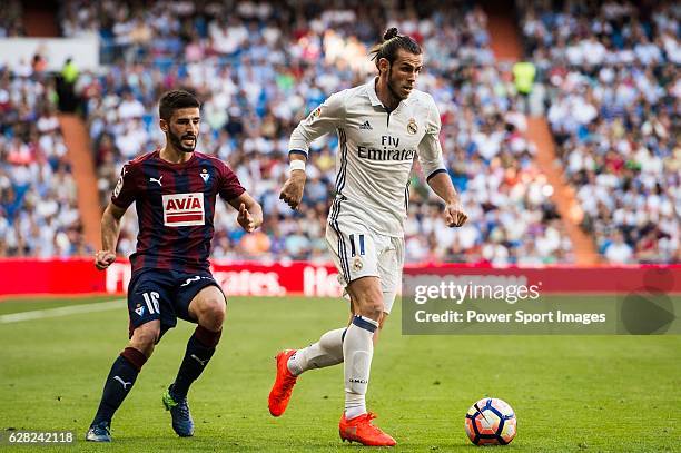 Gareth Bale of Real Madrid runs past Fran Rico of SD Eibar during their La Liga match between Real Madrid CF and SD Eibar at the Santiago Bernabeu...