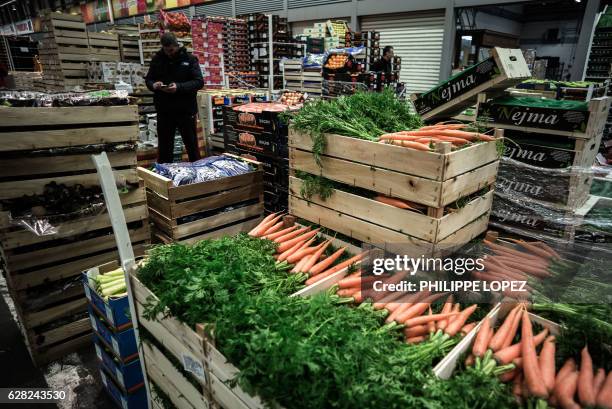 Man stands by his stall at the fruits and vegetables pavilion of the Rungis international food market in Rungis, a southern suburb of Paris on...