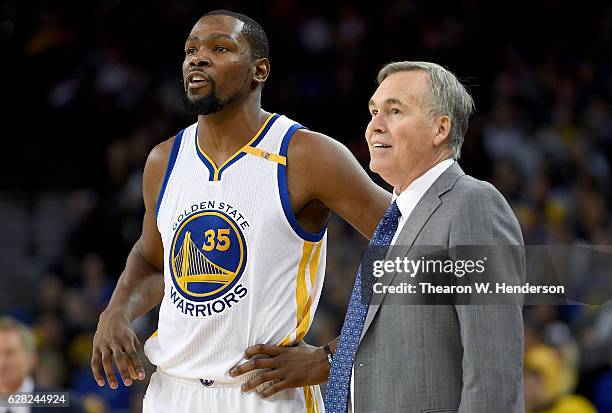 Head coach Mike D'Antoni of the Houston Rockets talks with Kevin Durant of the Golden State Warriors during a break in the action of an NBA...