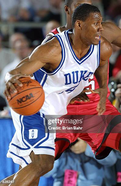 Nate James of Duke drives around the Maryland defense during the semifinal of the Men's NCAA Basketball Final Four tournament at the Metrodome in...